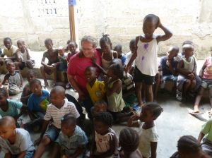 Team Director McGrath surrounded by grateful children at Christmas!
