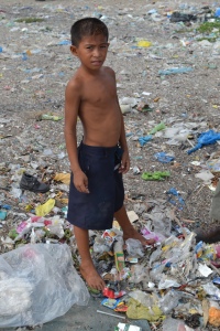 This boy's life consists of no school, no work, no playground, he will search through garbage everyday just to find enough plastic to sell for less then fifty cents if he is lucky. 