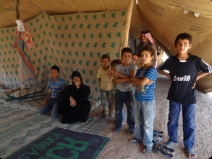 More than one million children are refugees. This family of nine lives under this shelter made out of blankets. 