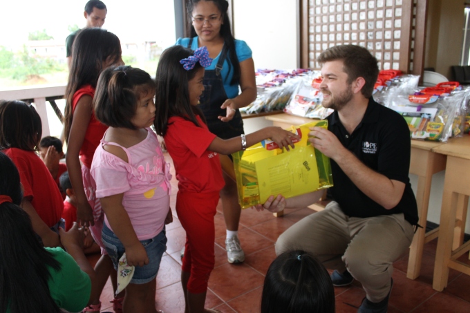 CHRF Project Coordinator Marcus Begley provides children with school supplies in Manila.